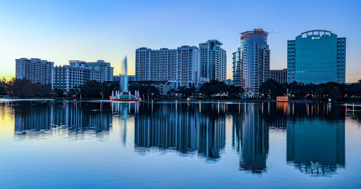 Downtown Orlando skyline reflected across Lake Eola at sunrise