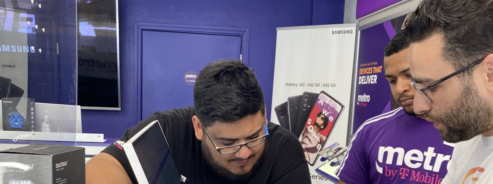 Celltronix team members working behind the counter inside one of the stores, the business where Evan Ross learned the difference between managing a company and running one