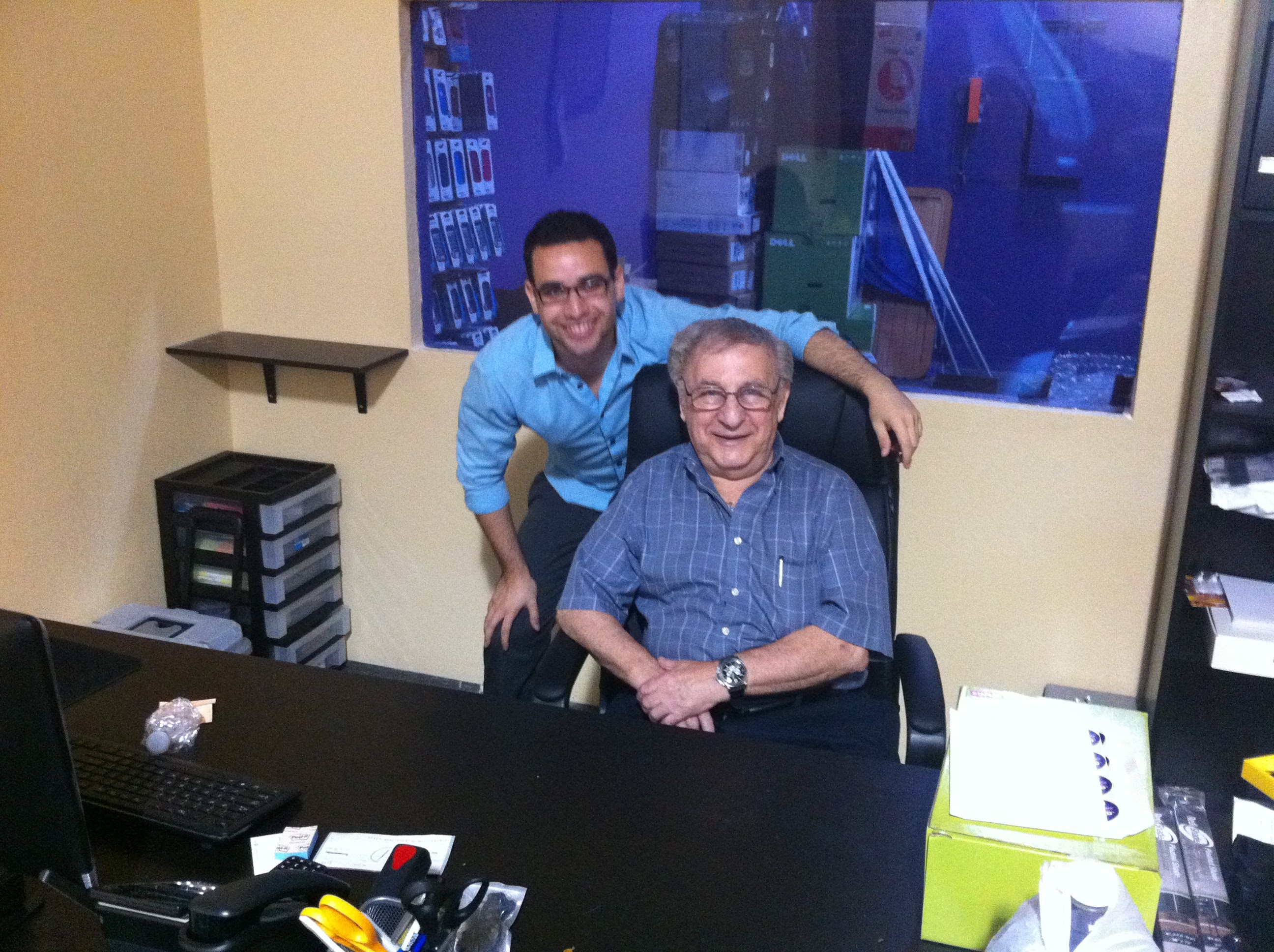 Evan and his grandfather at a later Celltronix office - the business had grown